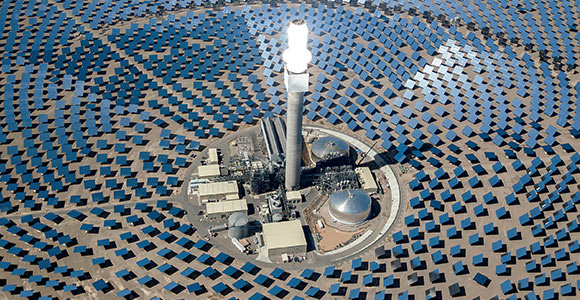 Image of a factory surrounded by Solar Panels 