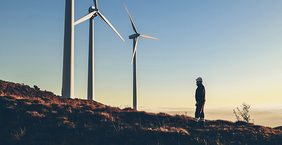 Three large wind turbines in a row.