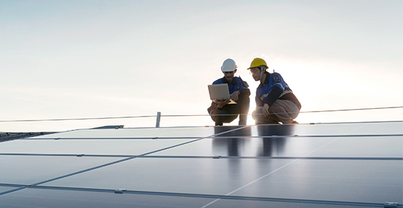 2 Engineers atop a solar paneled roof