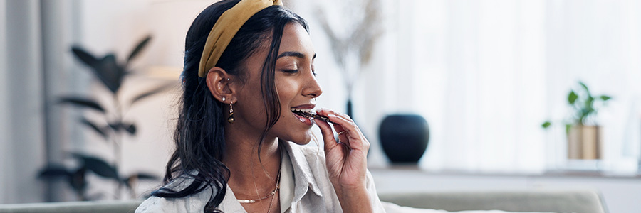 A person enjoying a bite of chocolate.