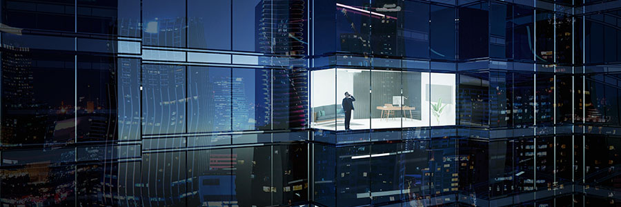 Looking inside a tall office building at a businessperson talking on the phone.