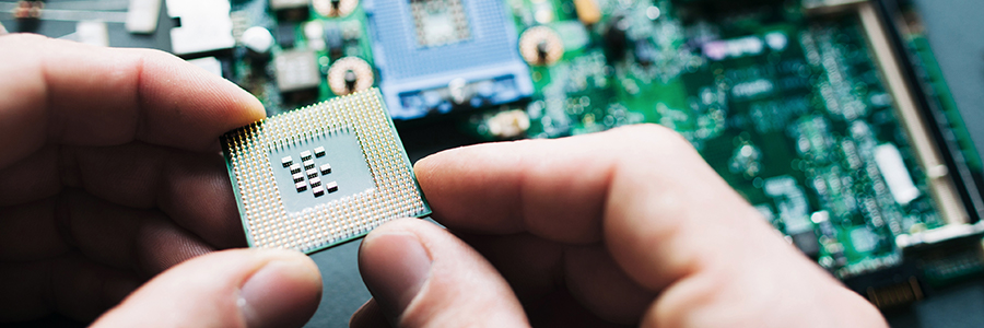 Two hands holding a computer CPU chip.