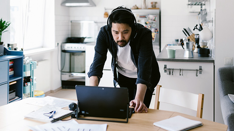 A person on his laptop working from home