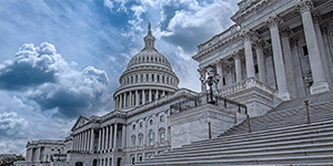 The steps outside the Capitol building in Washington D.C. with turbulent clouds behind.